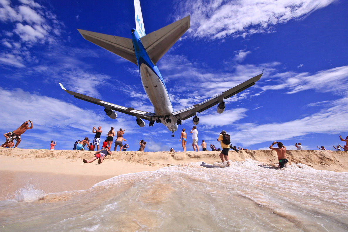 Самолет пролетает над пляжем
